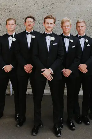 Out of town groomsmen showing off their rented tuxedos