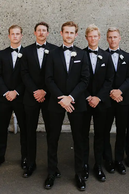 Out of town groomsmen showing off their rented tuxedos